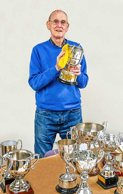 Gordon-polishing-trophies.webp